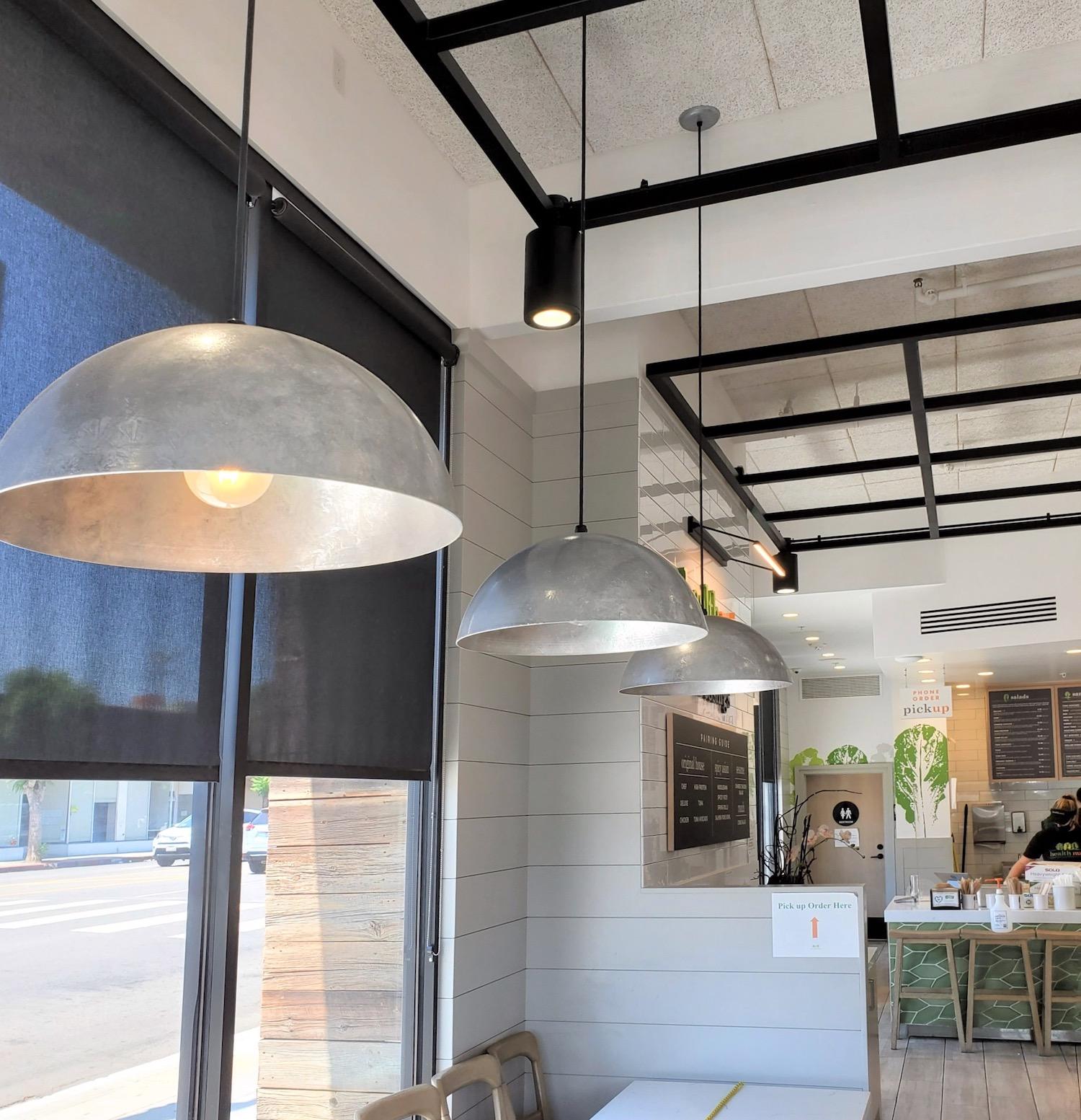 Industrial pendant lighting installed in a contemporary hospitality interior.
