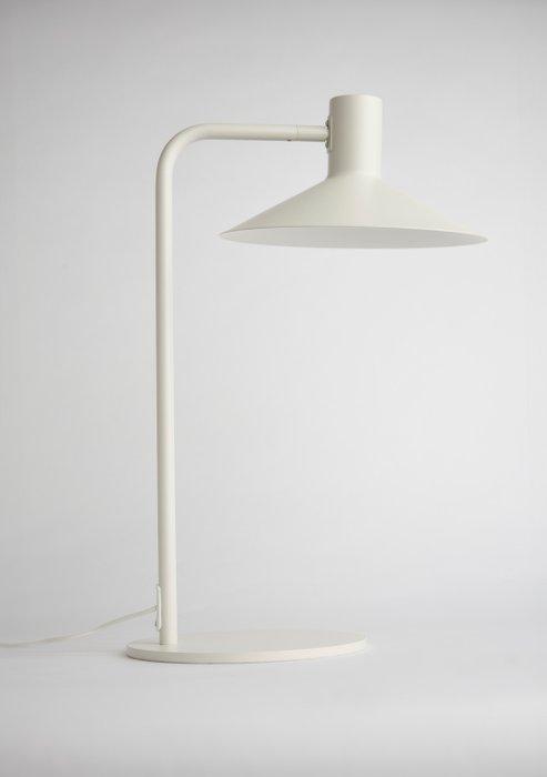 Front view of a minimalist table lamp highlighting its refined proportions and architectural design.