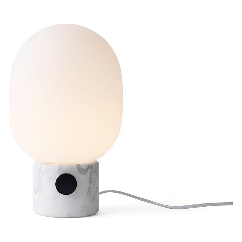 Minimal table lamp photographed on a clean white background showcasing its simple geometric form and premium finish.