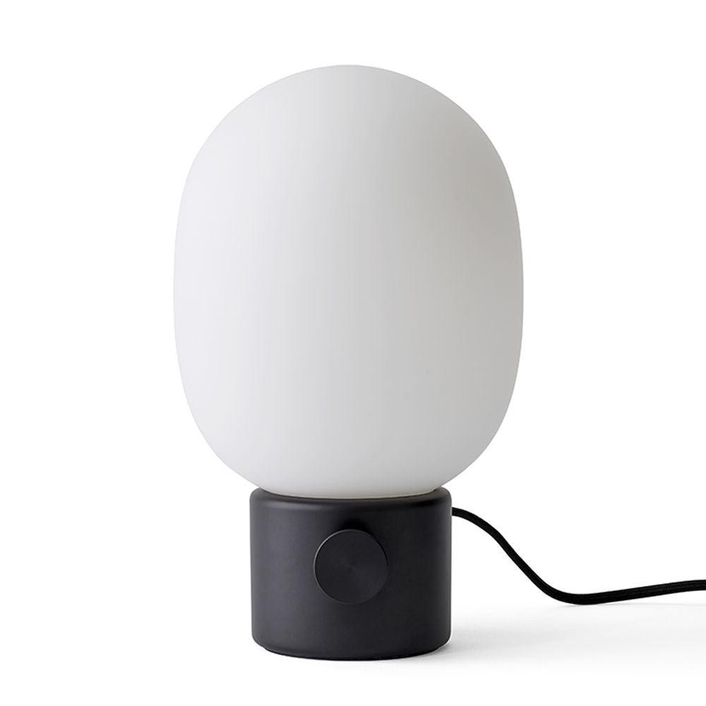 Minimal table lamp photographed on a clean white background showcasing its simple geometric form and premium finish.