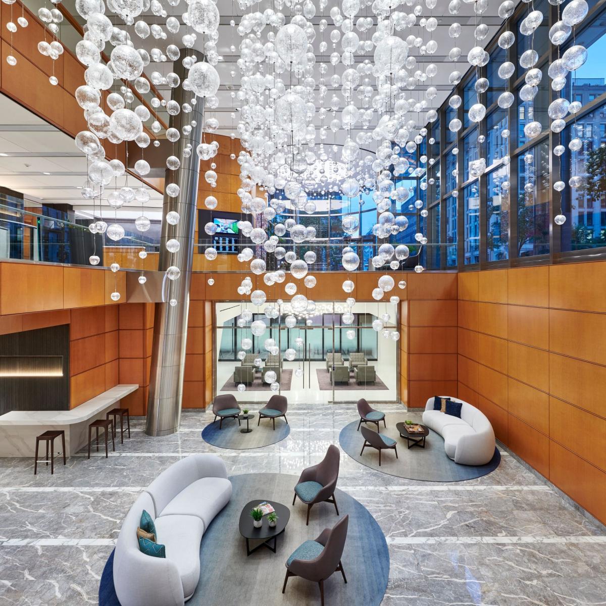 Contemporary chandelier installed in a luxury hotel lobby.