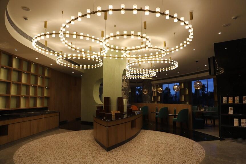 Contemporary chandelier installed in a luxury hotel lobby.