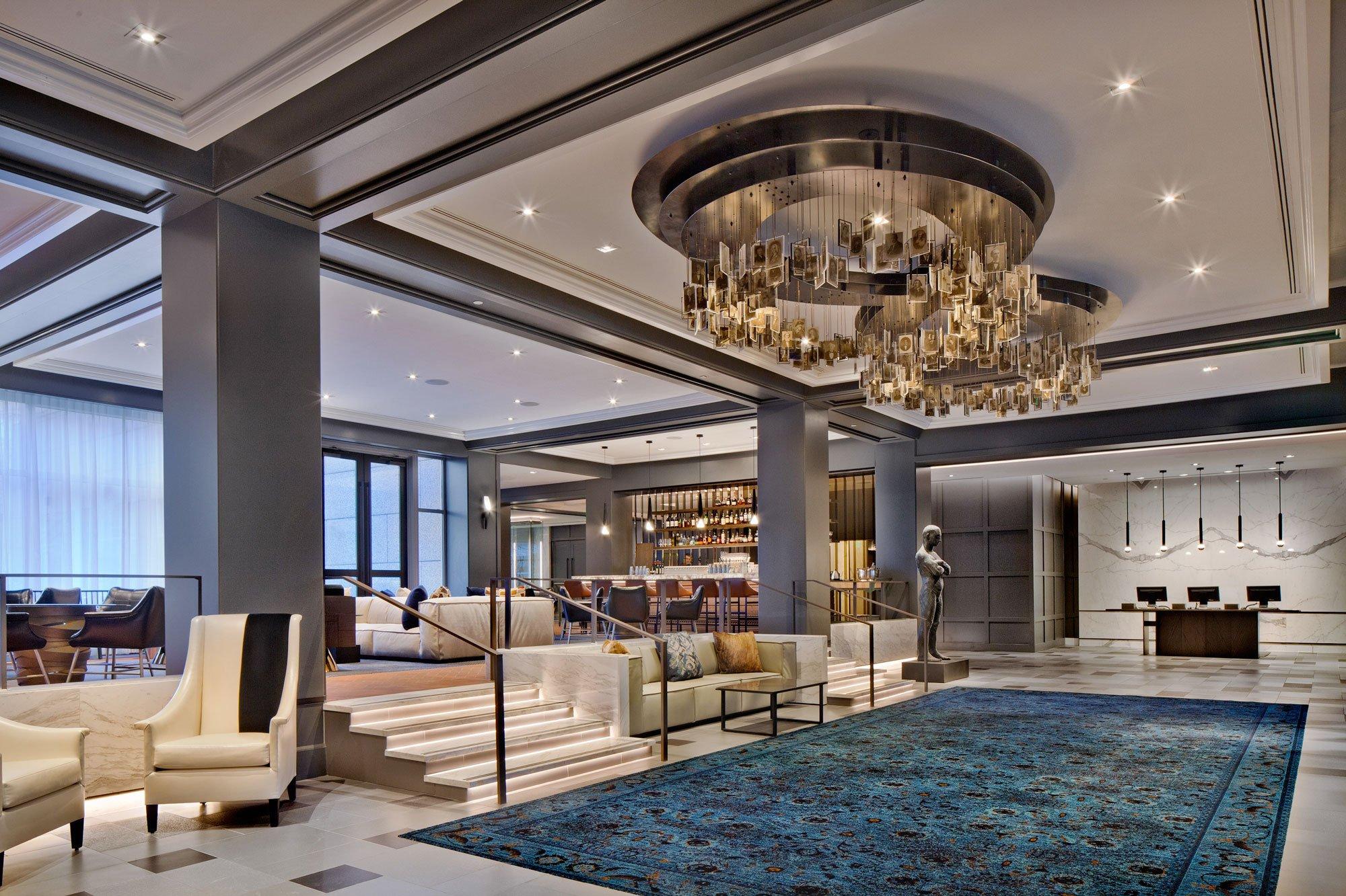 Contemporary chandelier installed in a luxury hotel lobby.