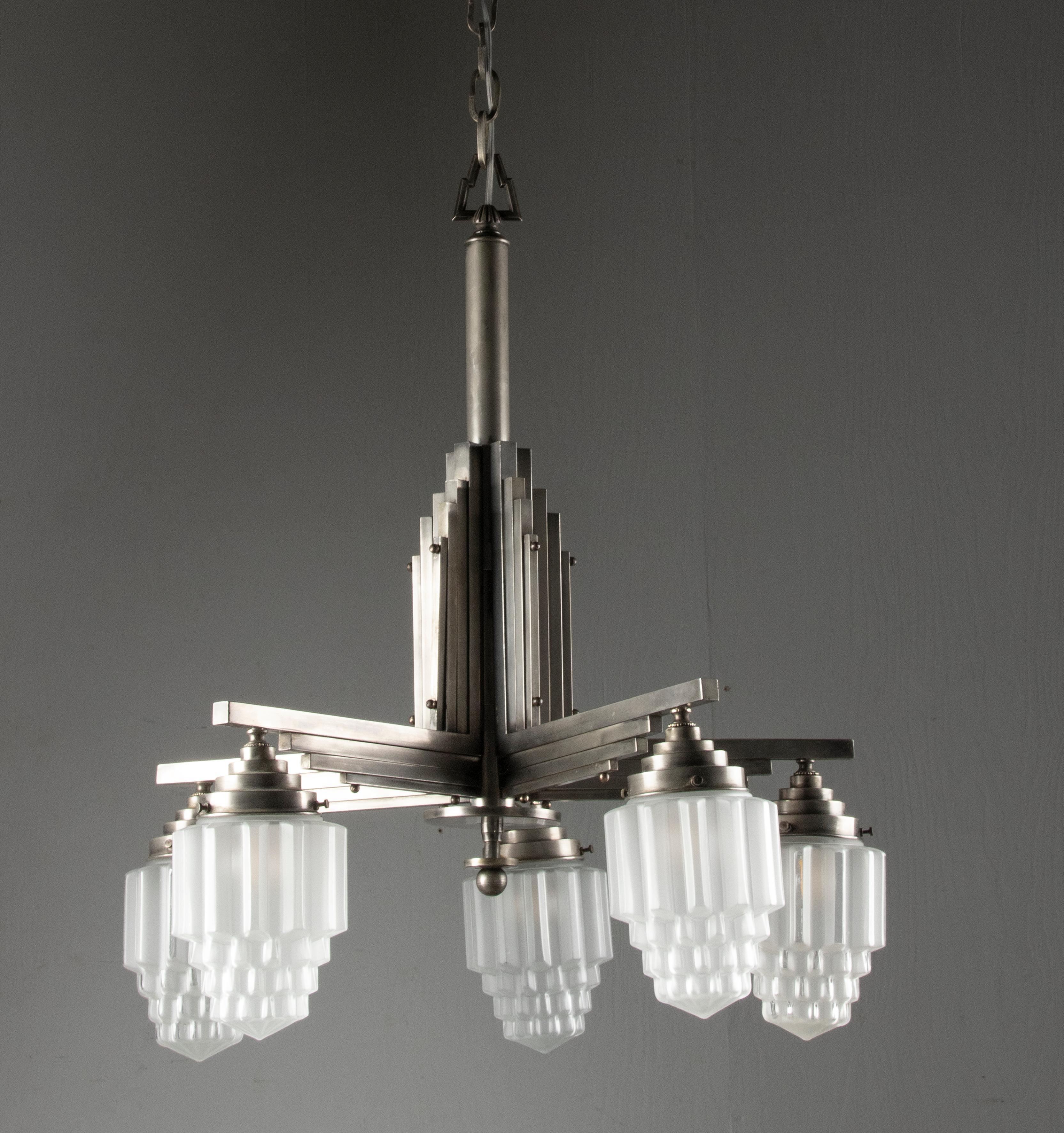 Front view of an elegant Art Deco chandelier with geometric detailing.
