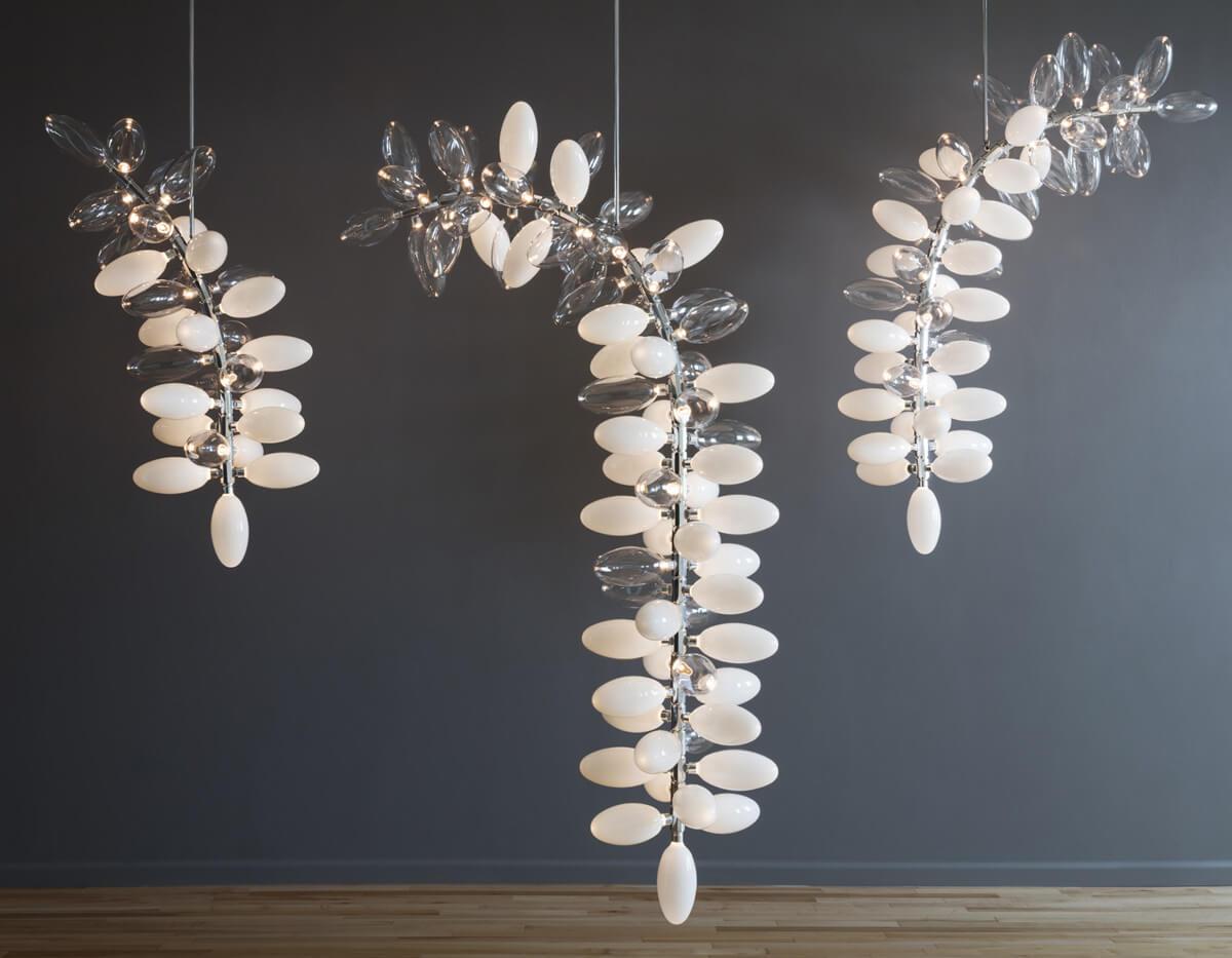 Sculptural chandelier family featuring multiple artistic compositions and sizes.
