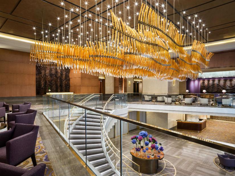Sculptural chandelier installed in a contemporary hospitality or cultural interior.