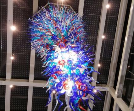 Sculptural chandelier installed in a contemporary hospitality or cultural interior.