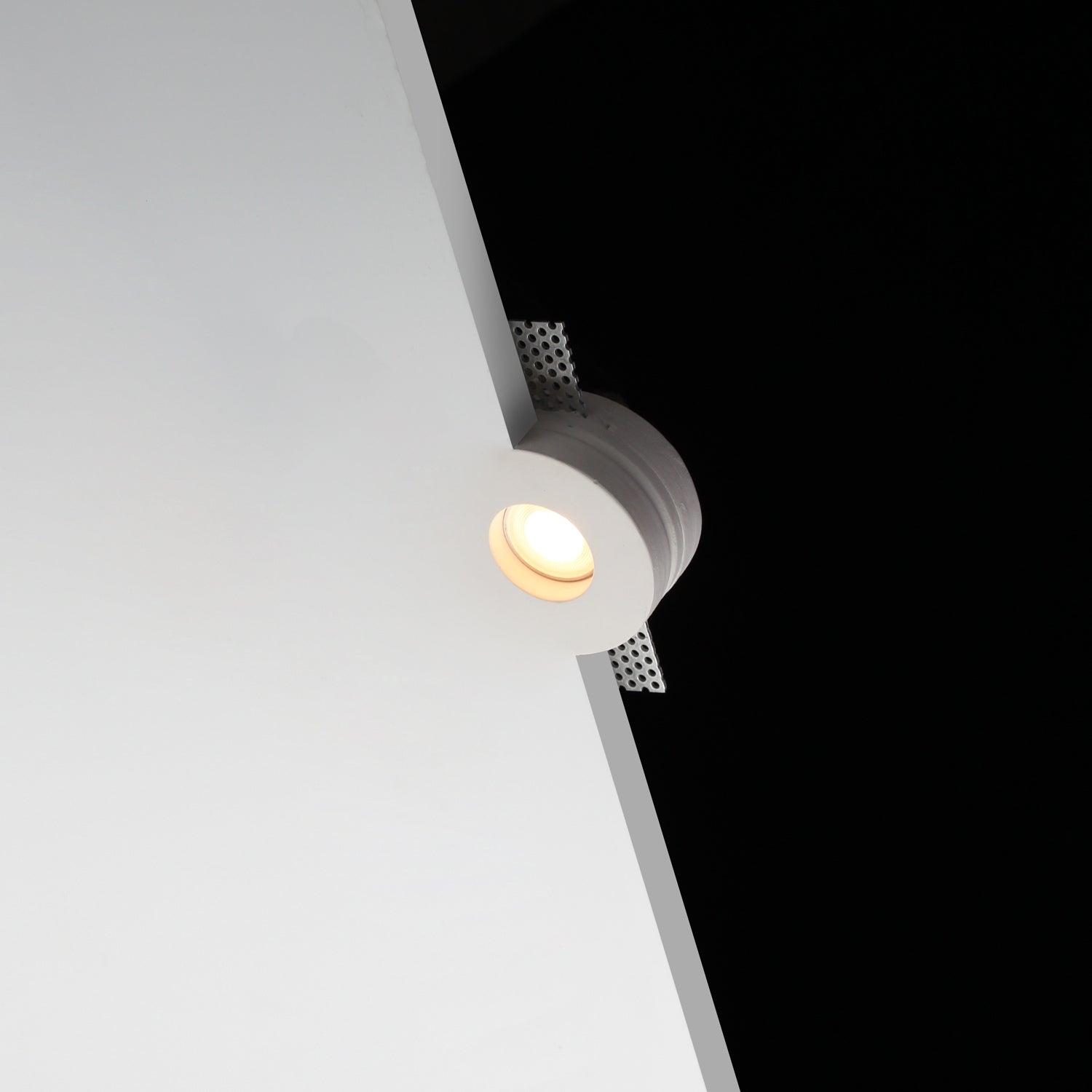 Front view of a trimless recessed architectural downlight.