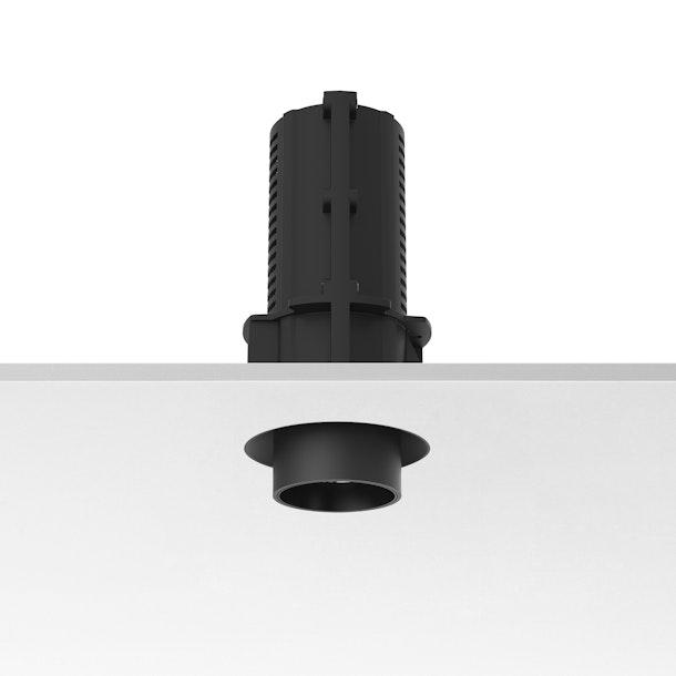 Front view of a trimless recessed architectural downlight.