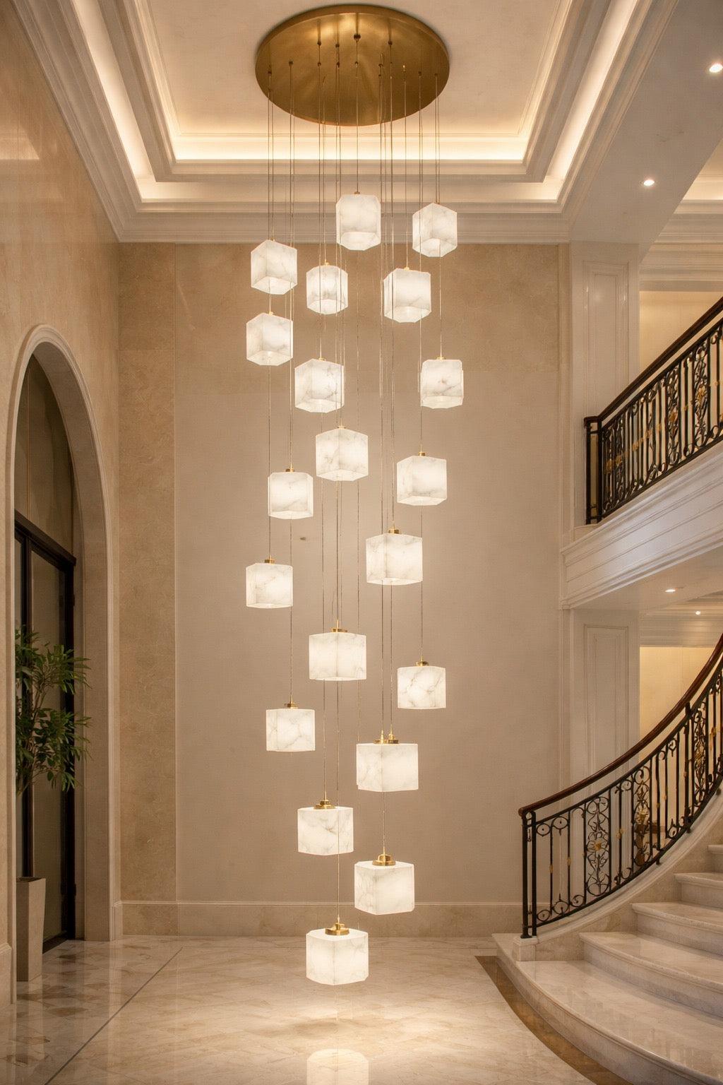 Luxury marble chandelier installed above a dining table in a contemporary hospitality interior, creating a refined architectural focal point.