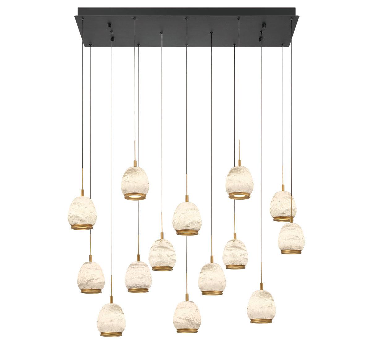 Marble chandelier photogLuxury marble chandelier installed above a dining table in a contemporary hospitality interior, creating a refined architectural focal point.raphed on a clean white studio background showcasing genuine natural stone and premium metal detailing.