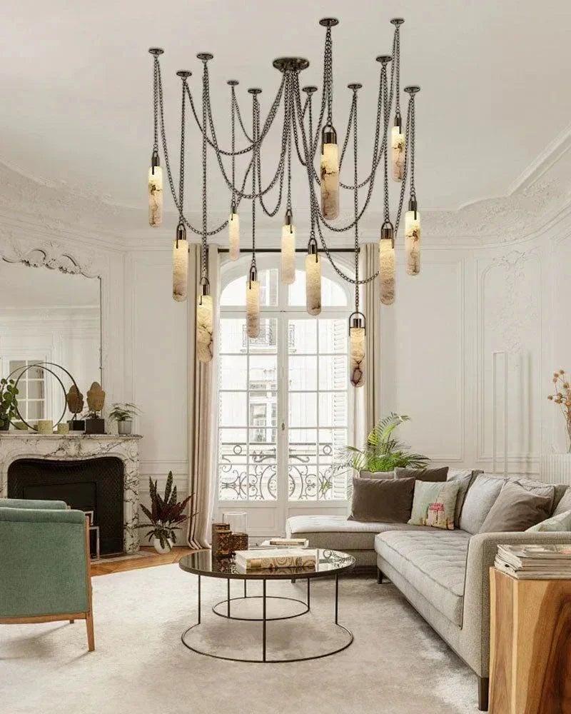 Luxury marble chandelier installed above a dining table in a contemporary hospitality interior, creating a refined architectural focal point.