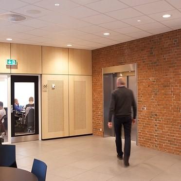 Emergency recessed downlights installed in a commercial corridor.