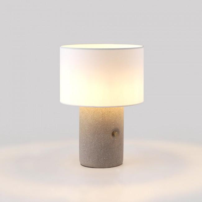 Front view of a bedside table lamp highlighting refined detailing and warm contemporary styling.
