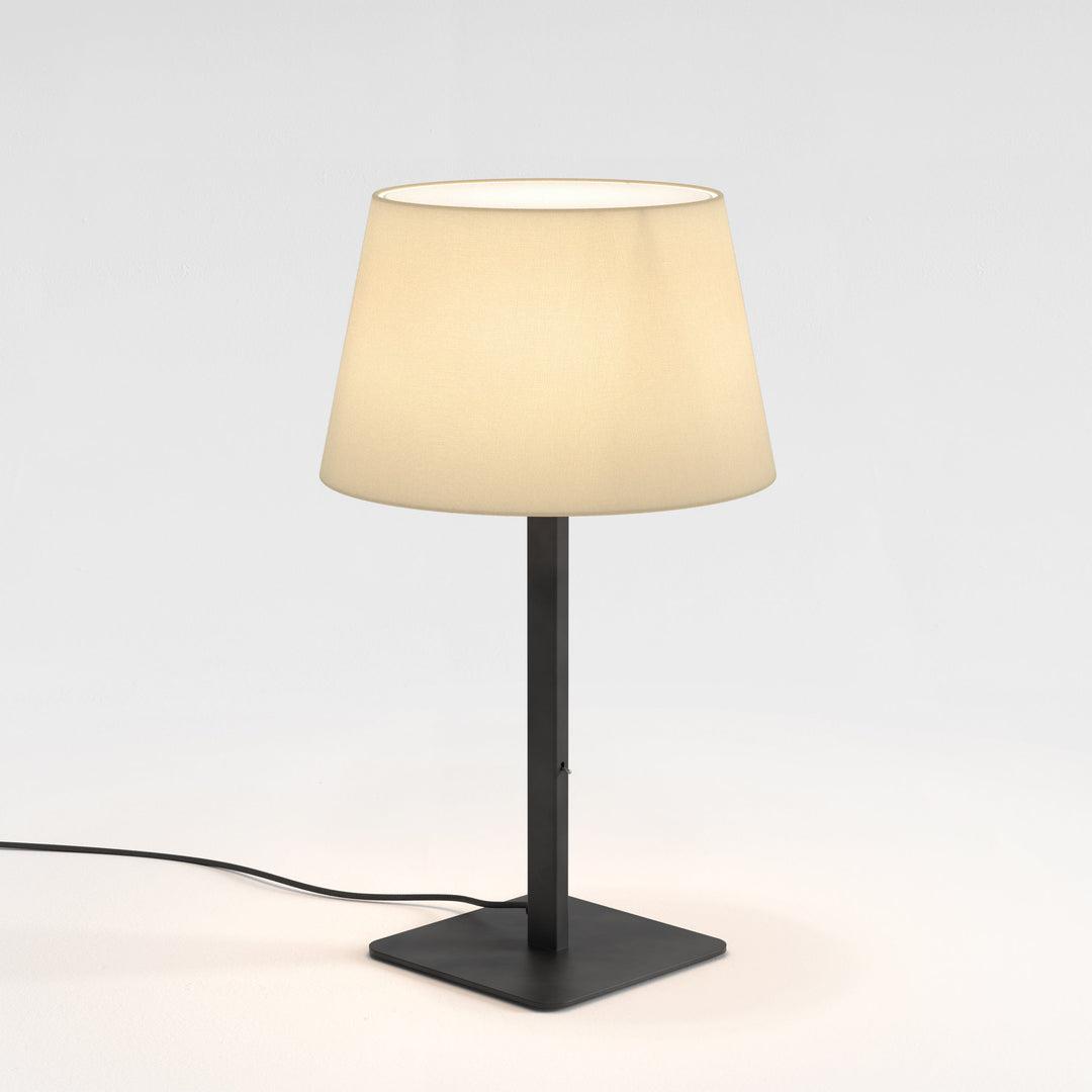Front view of a bedside table lamp highlighting refined detailing and warm contemporary styling.