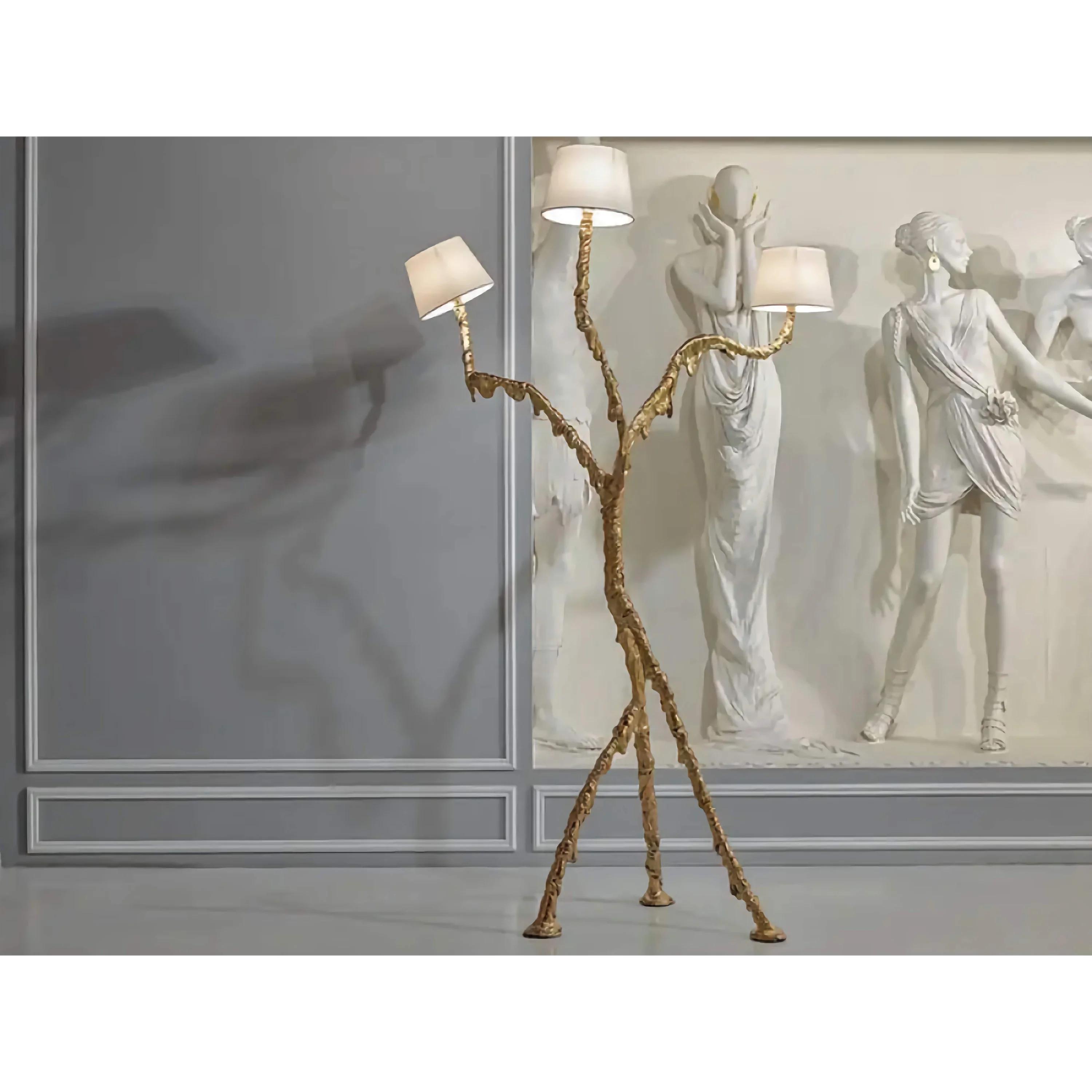 Sculptural floor lamp positioned in a luxury hotel lobby creating a dramatic architectural focal point with warm ambient illumination.