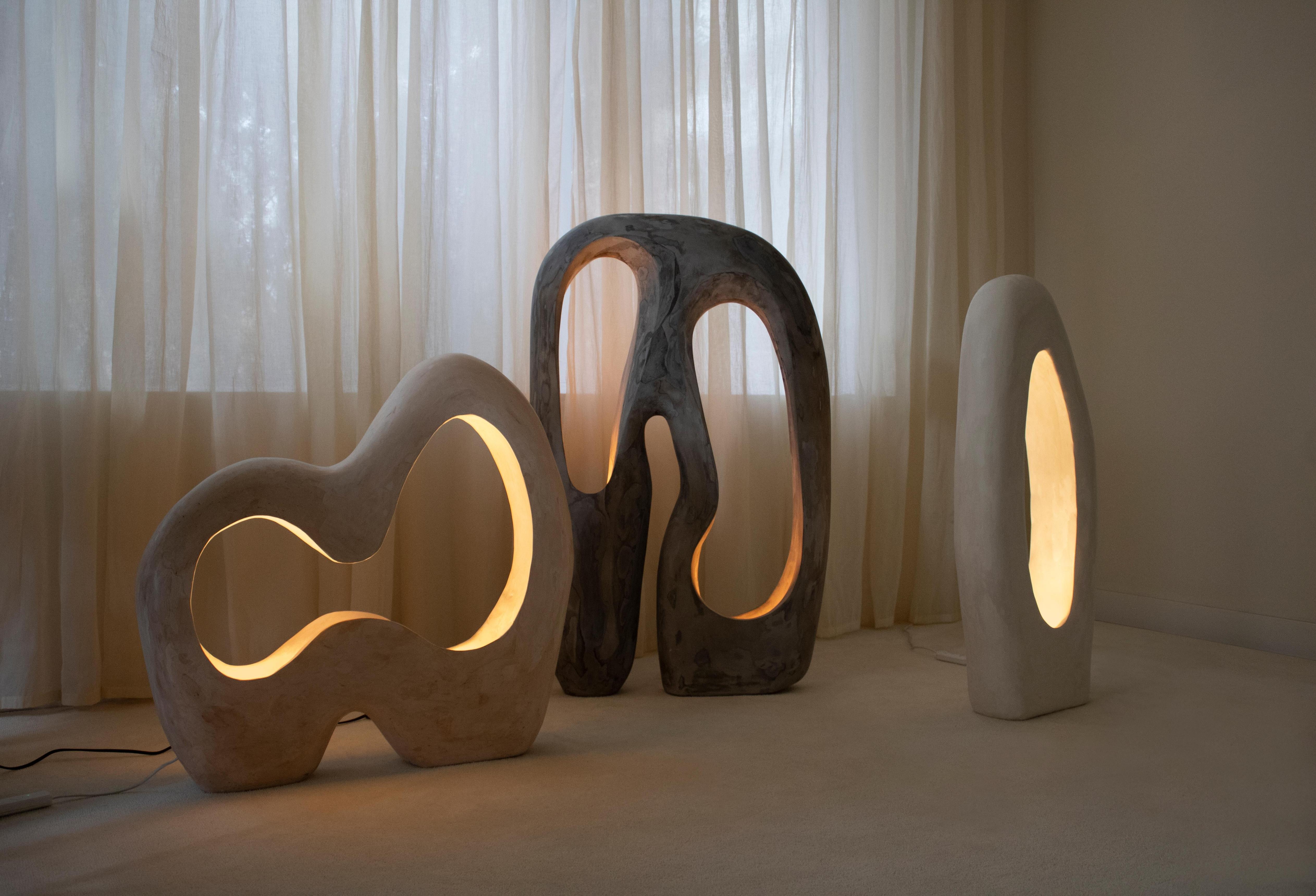 Collection of sculptural floor lamps featuring contemporary artistic forms and premium decorative finishes.