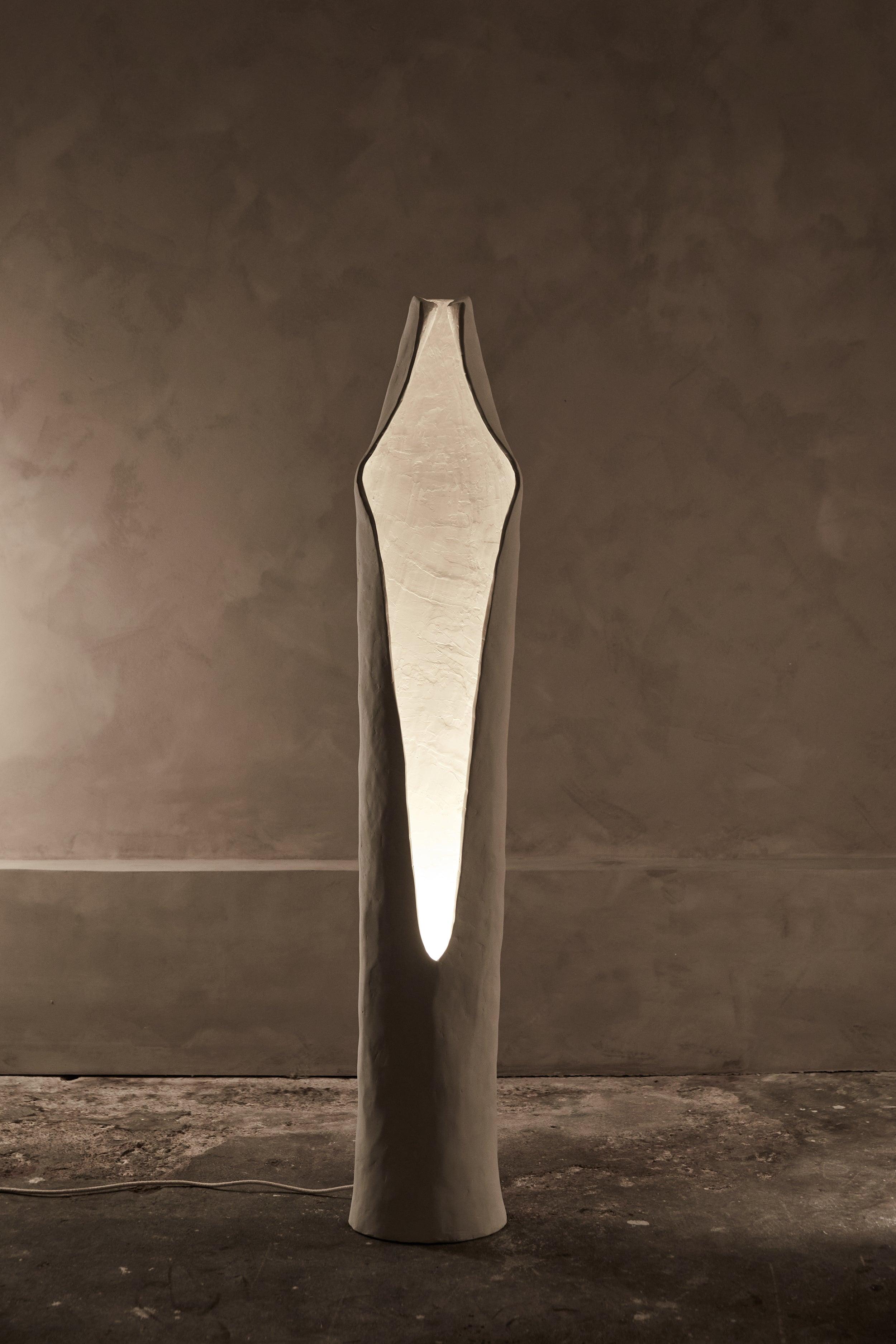 Front view of a sculptural floor lamp highlighting abstract geometry, elegant proportions and refined architectural detailing.