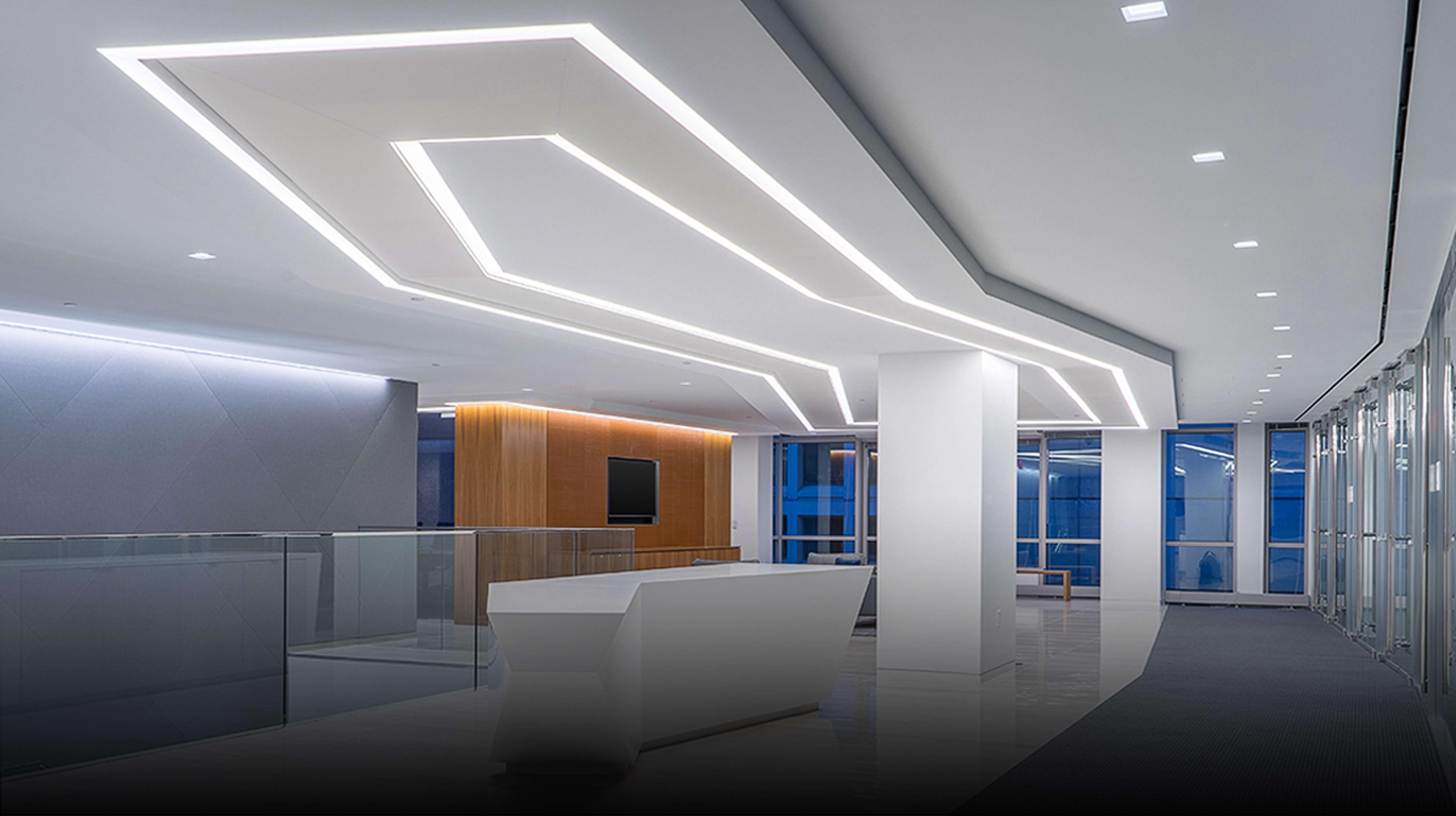 Floating ceiling cove lighting creating indirect illumination in a contemporary hospitality interior.