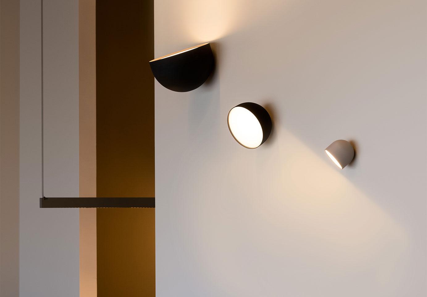 Modern wall lamp family featuring multiple finishes and contemporary designs.