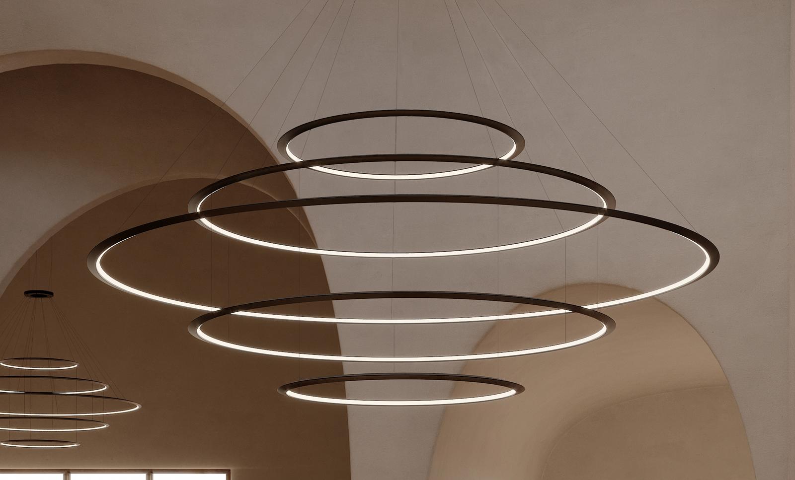 Ring pendant lighting installed in a modern office lobby.