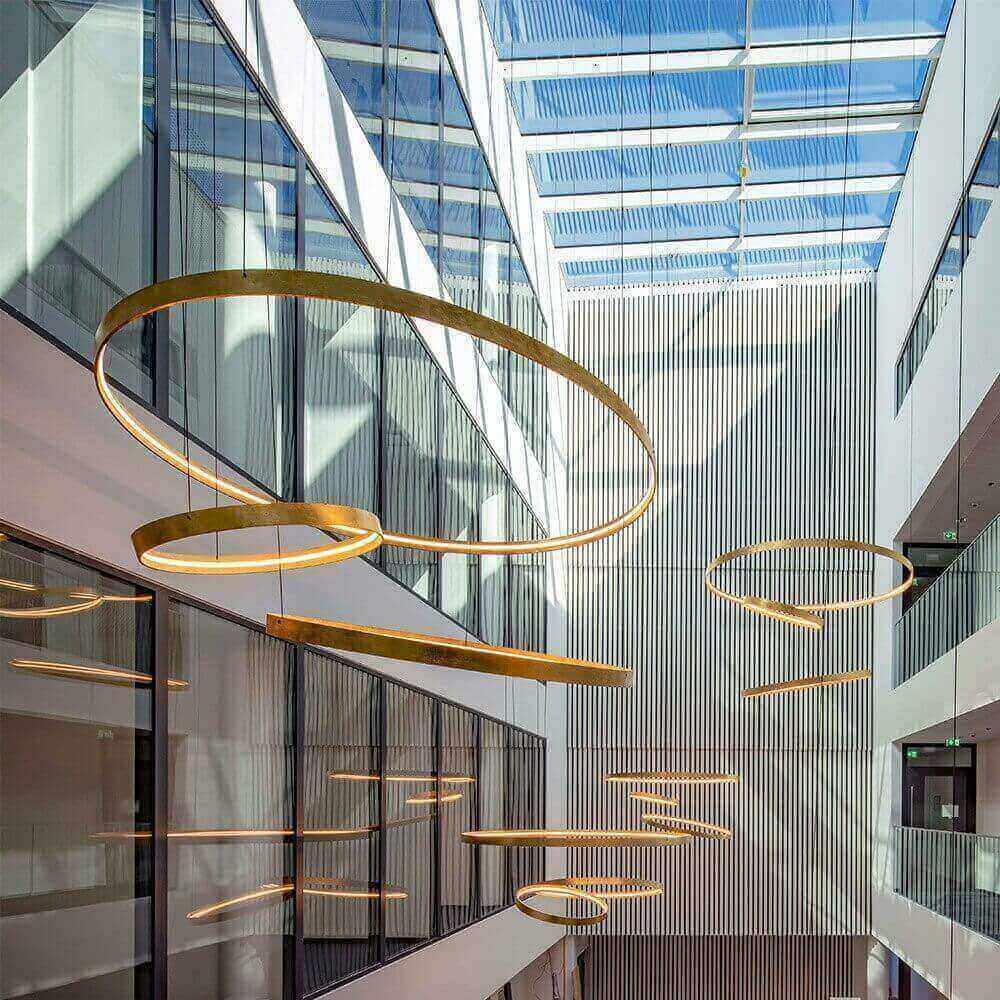 Ring pendant lighting installed in a modern office lobby.