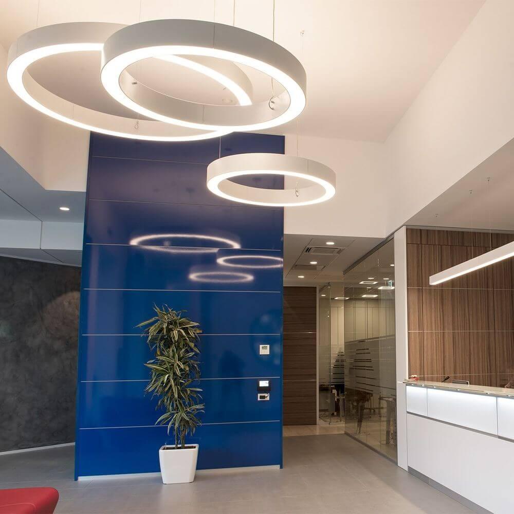 Ring pendant lighting installed in a modern office lobby.