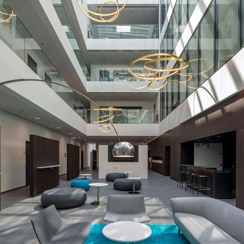 Ring pendant lighting installed in a modern office lobby.