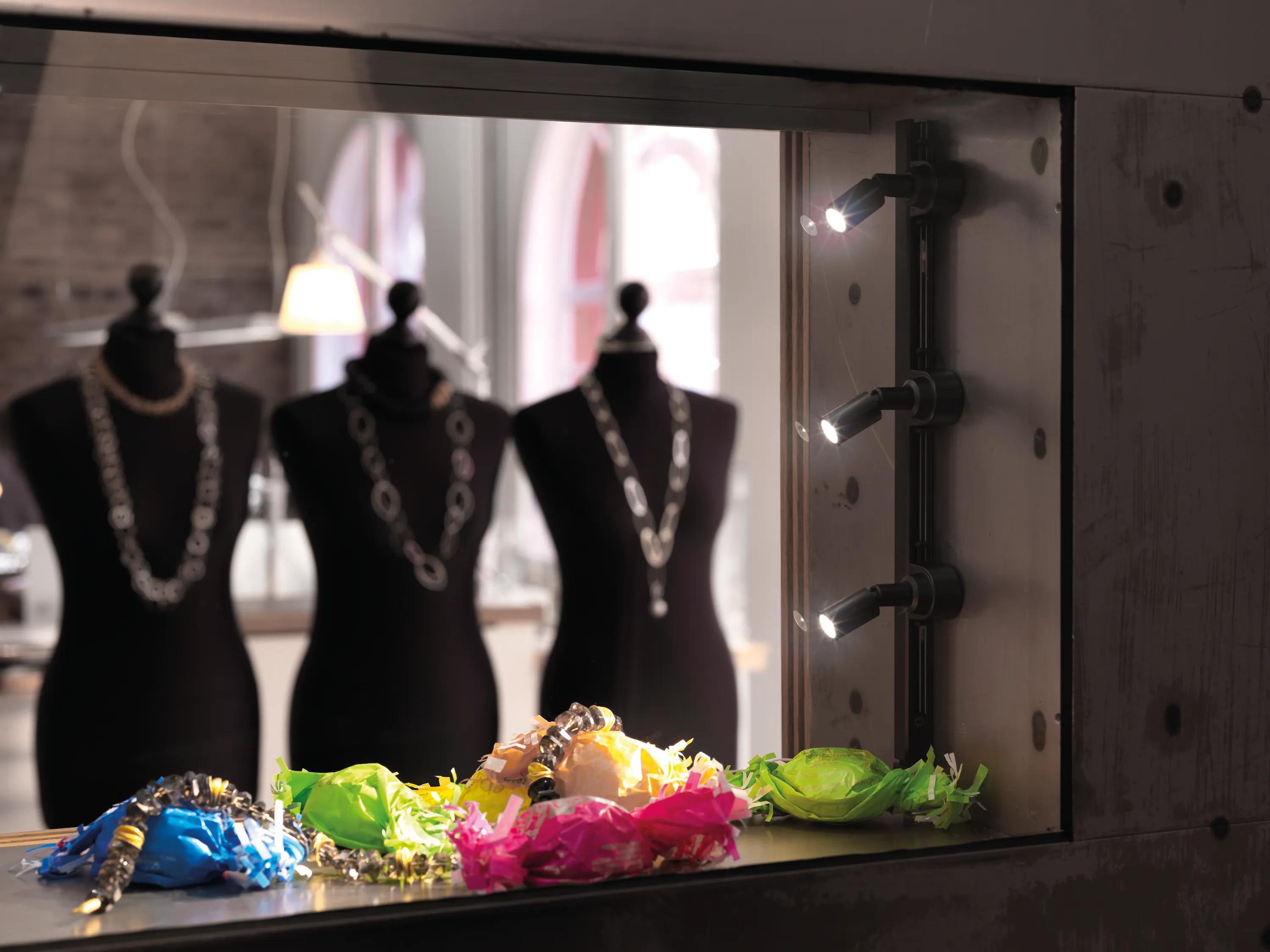 Magnetic adjustable spotlights highlighting products in a contemporary retail environment.