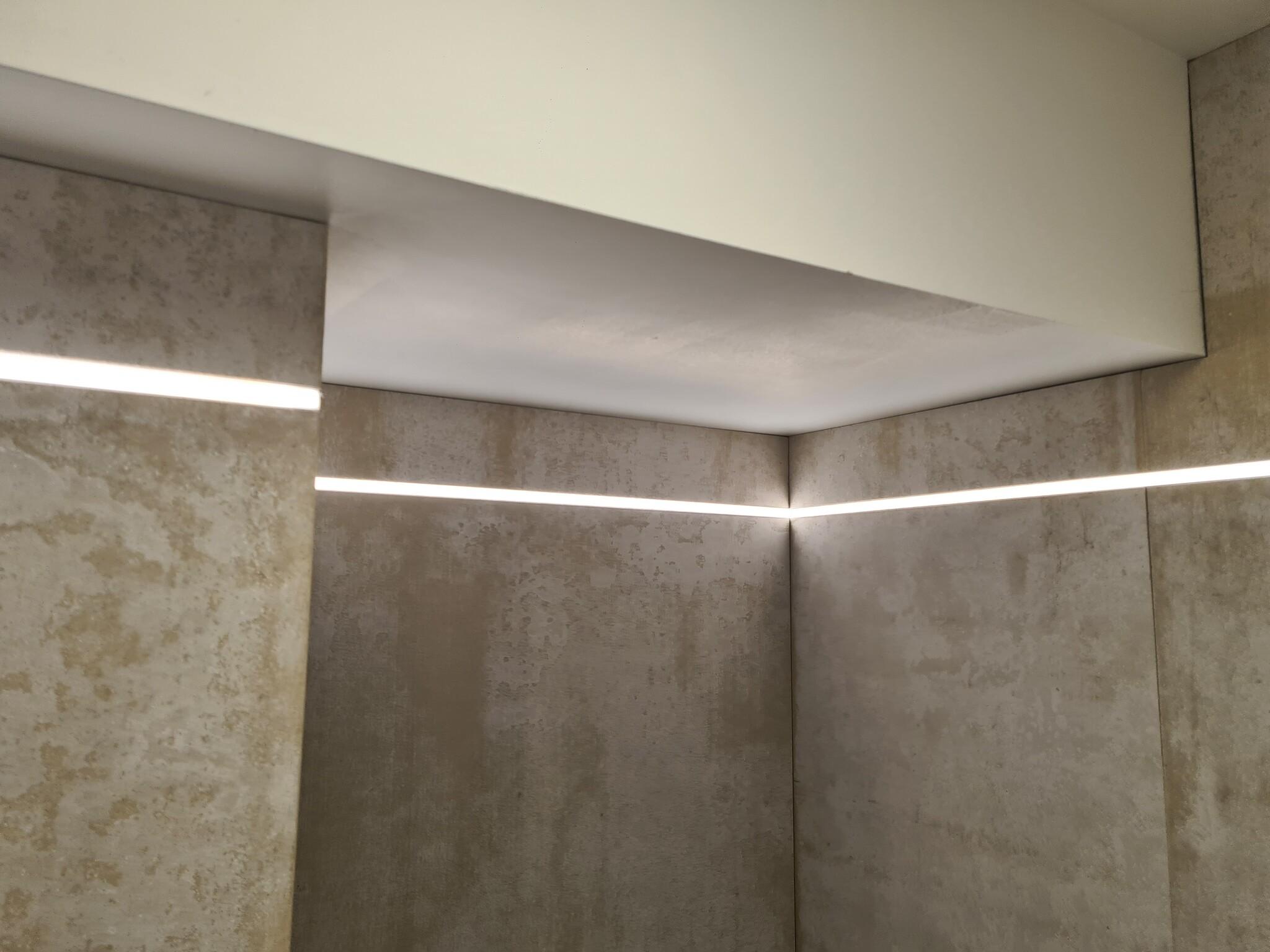 Drywall LED profile seamlessly integrated into a contemporary gypsum ceiling and wall.