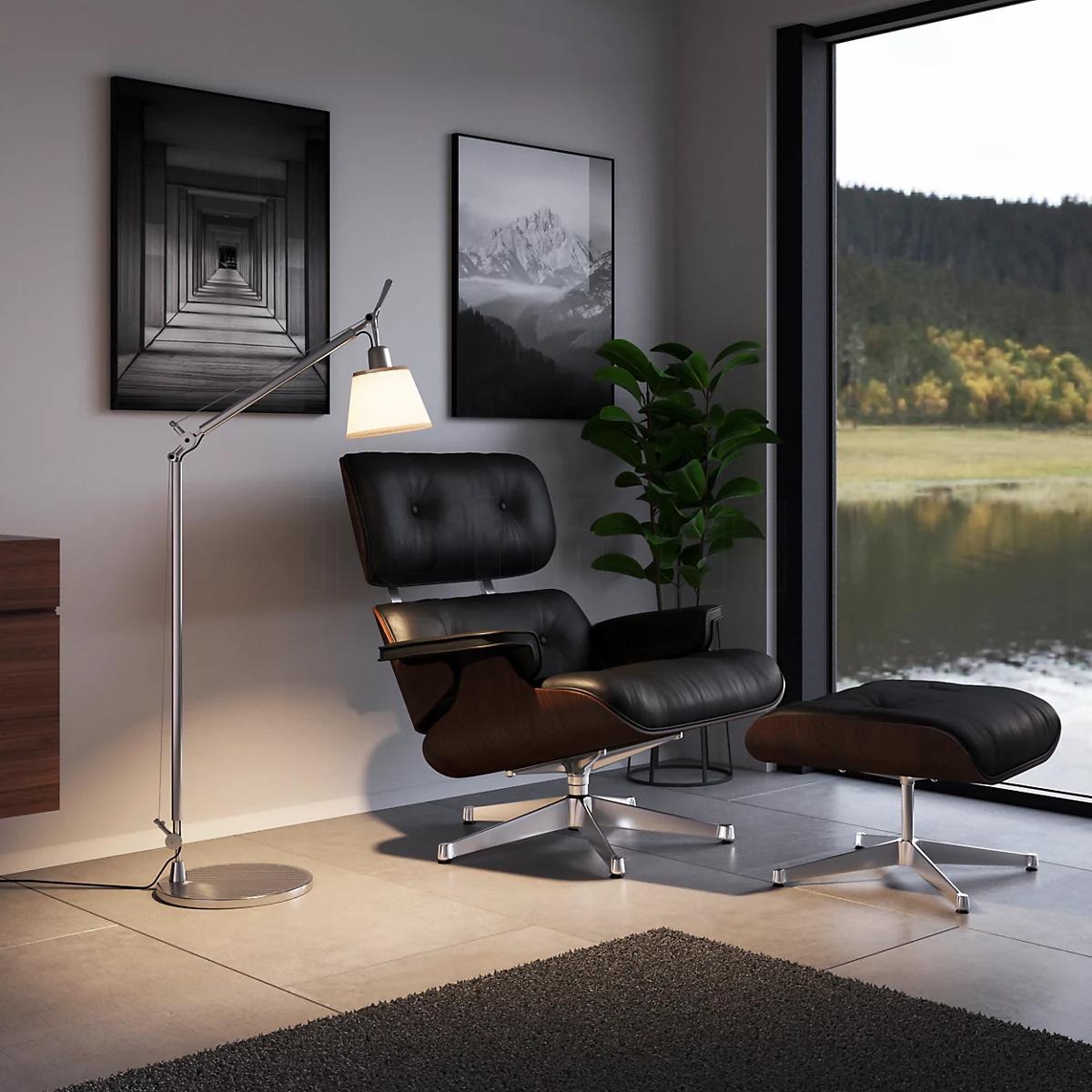 Reading floor lamp positioned beside a lounge chair in a contemporary residential reading corner, providing comfortable focused illumination for extended reading sessions.