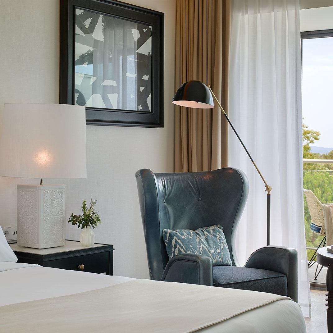 Reading floor lamp positioned beside a lounge chair in a contemporary residential reading corner, providing comfortable focused illumination for extended reading sessions.