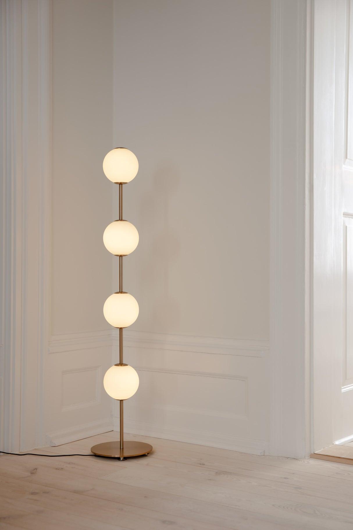 Front view of a globe floor lamp highlighting its elegant spherical diffuser and refined architectural proportions.