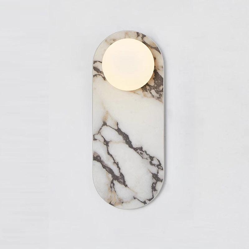 Front view of a luxury marble wall lamp highlighting the unique stone veining and refined architectural design.