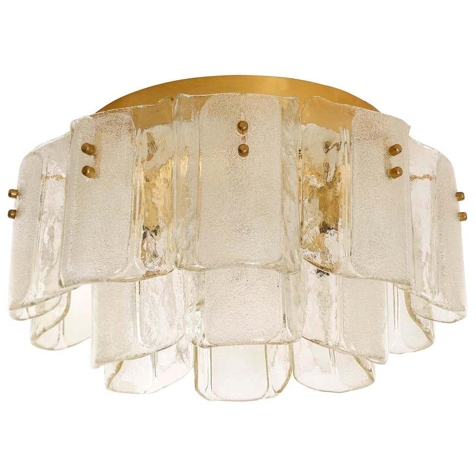 Luxury layered glass ceiling light with a refined decorative form on a white background