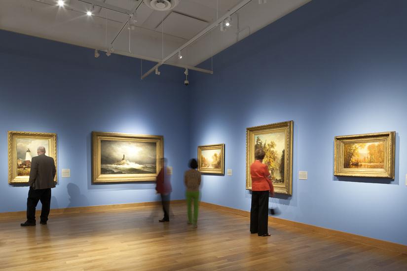 Museum track spotlights illuminating artwork in a gallery environment.