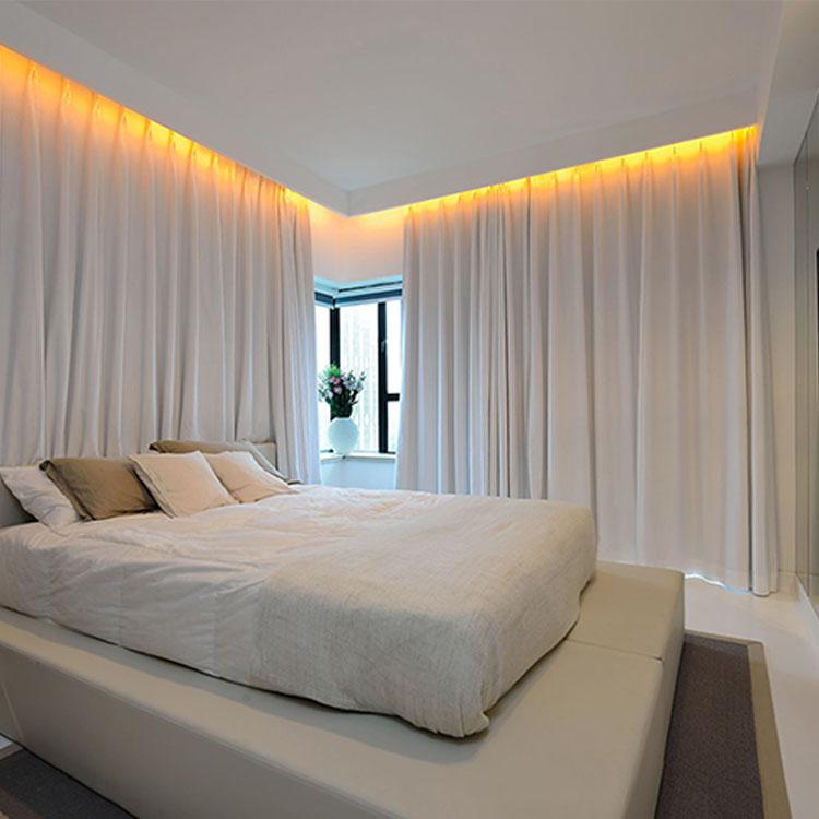 Curtain cove lighting integrated into a contemporary hospitality interior with floor-to-ceiling curtains.