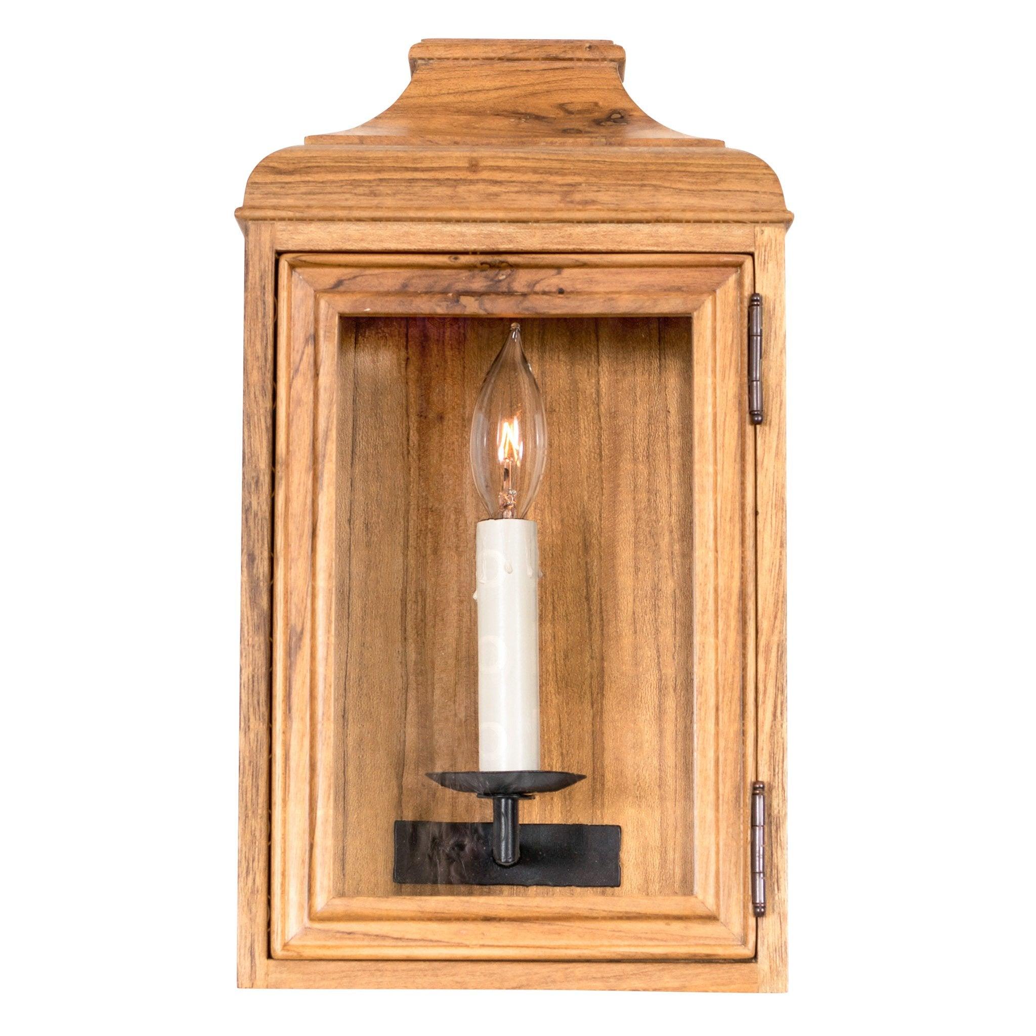 Rustic wall lamp featuring wood and wrought iron photographed on a clean white studio background.