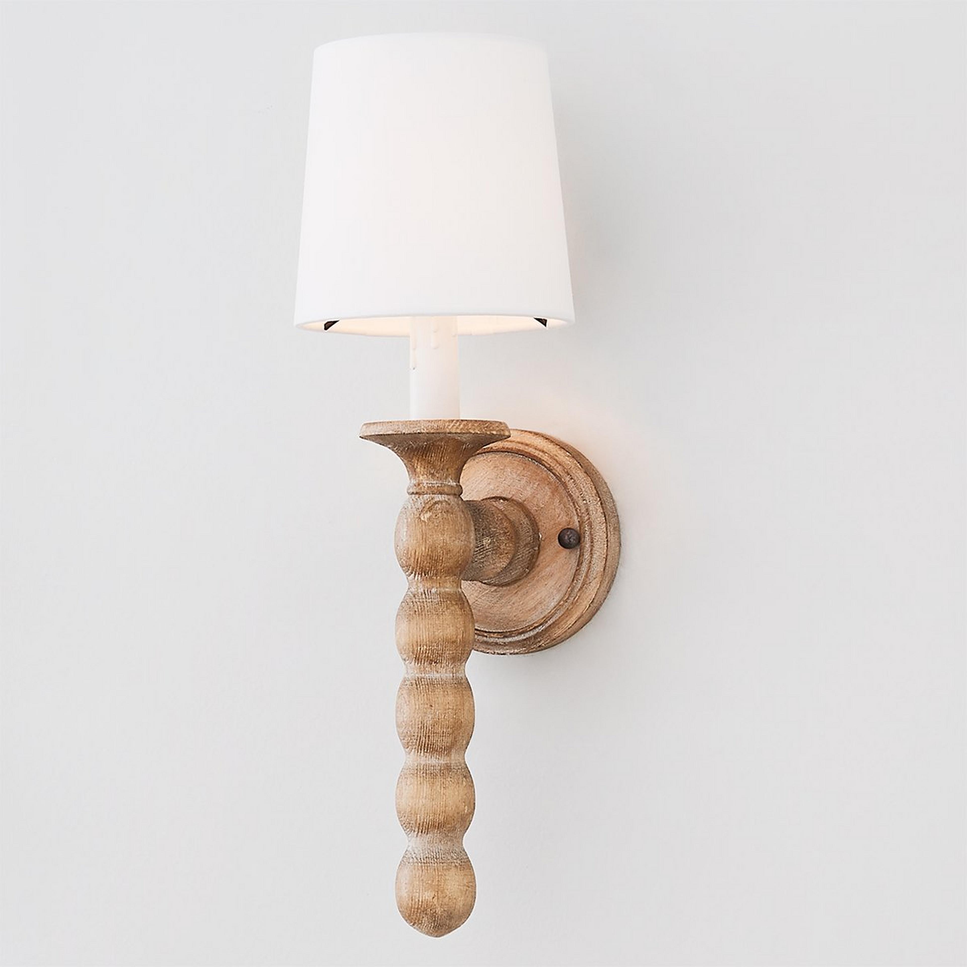 Front view of a handcrafted rustic wall lamp with natural materials.