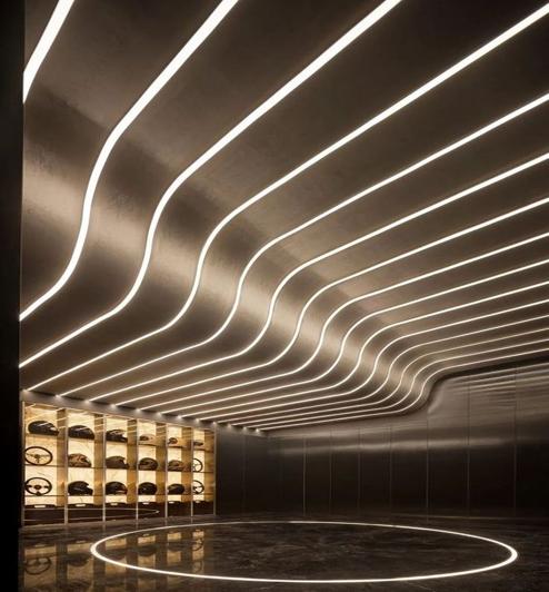 Bendable LED profile integrated into a curved ceiling and architectural feature wall.