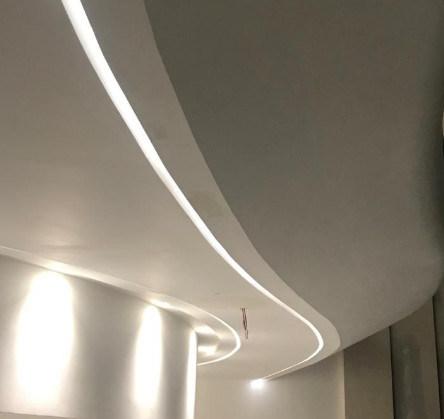 Bendable LED profile integrated into a curved ceiling and architectural feature wall.