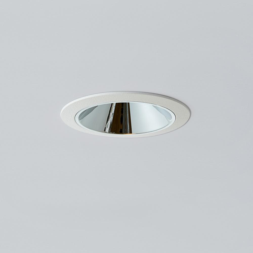 Front view highlighting the decorative reflector and recessed aperture.