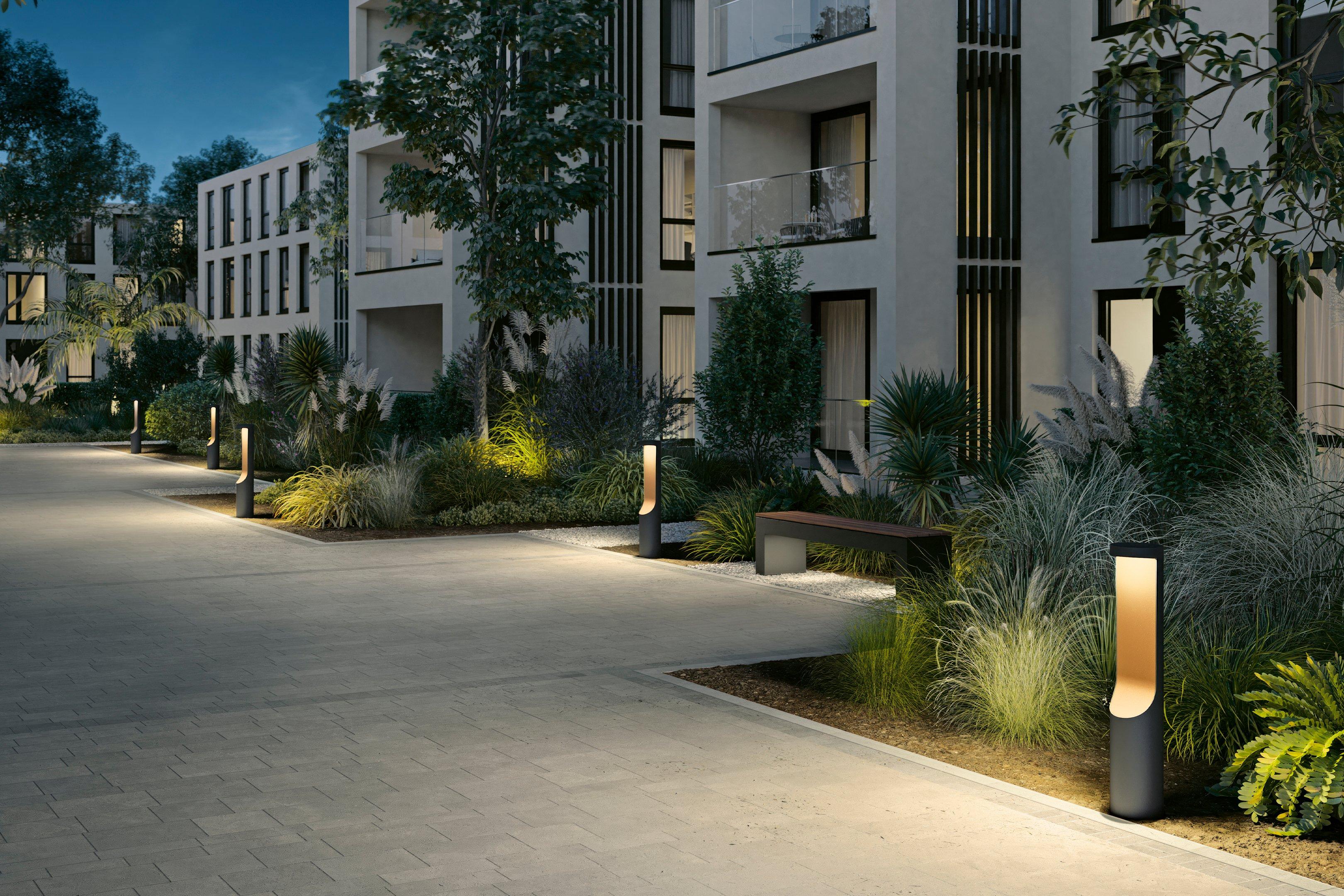Architectural bollard lights installed along a contemporary landscape pathway.