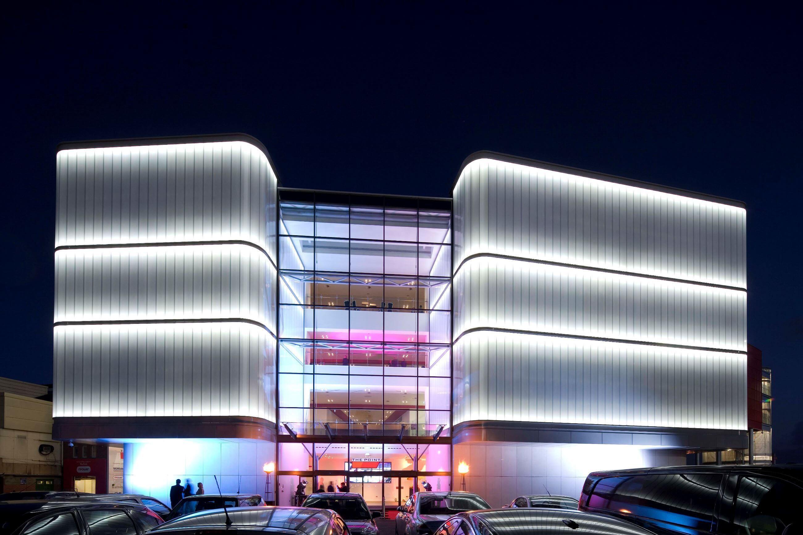 Dynamic White façade lights illuminating a contemporary hospitality building.