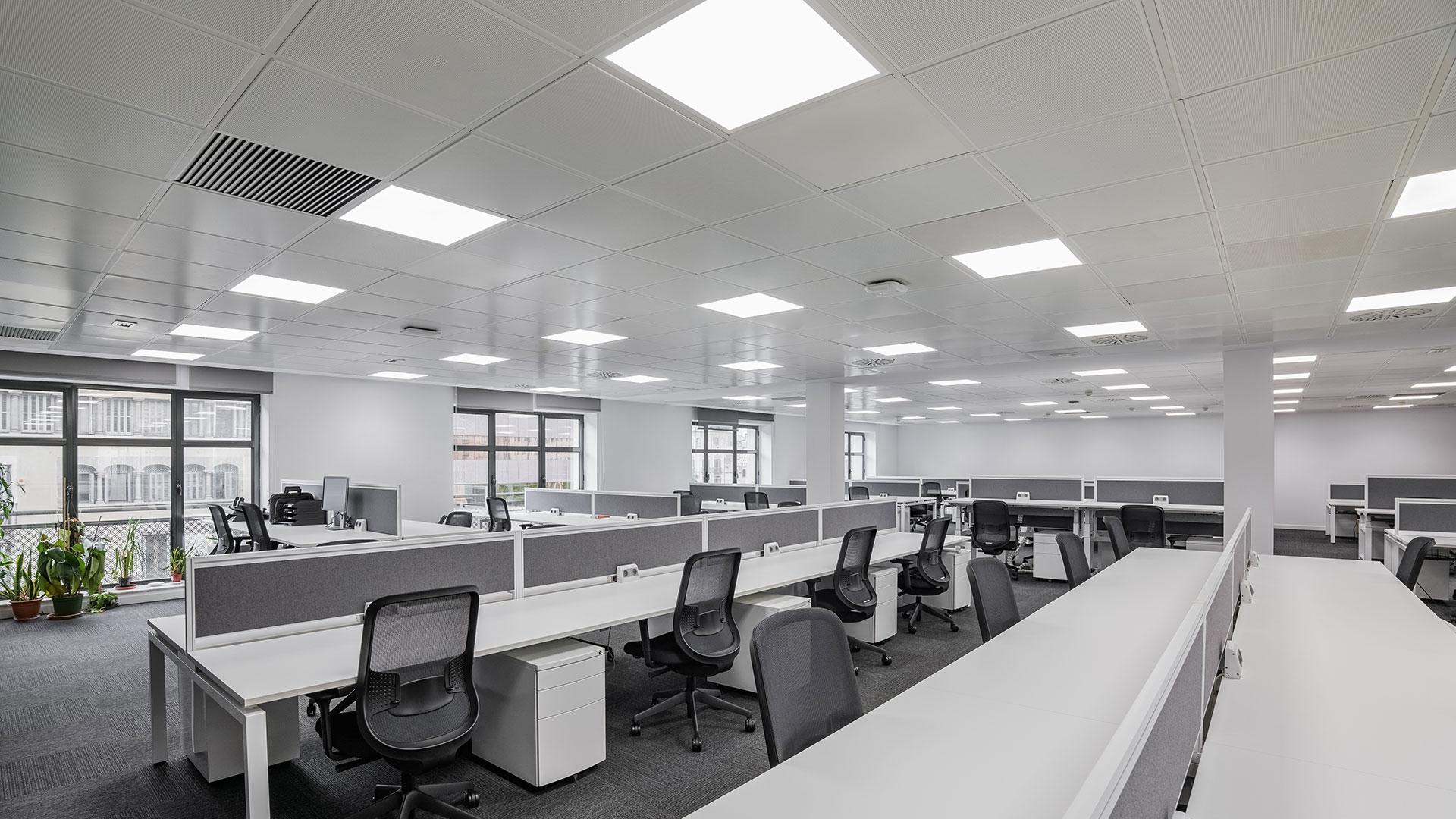 Microprismatic recessed panel lighting integrated into a contemporary office workspace