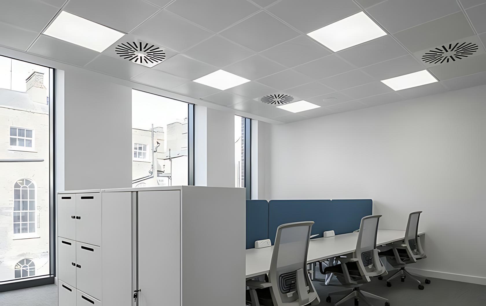 Microprismatic recessed panel lighting integrated into a contemporary office workspace