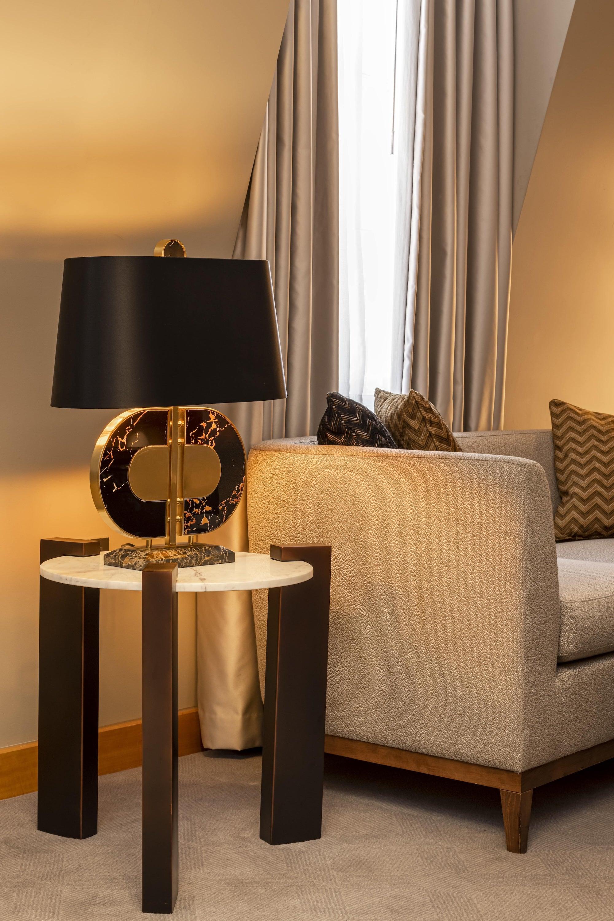 Luxury table lamp placed in a five-star hotel suite creating elegant ambient lighting and a prestigious interior atmosphere.