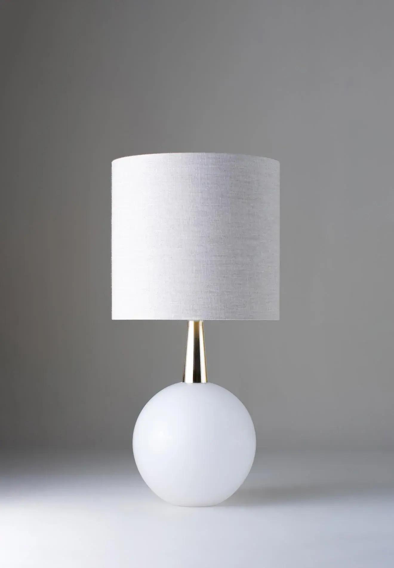 Front view of a luxury table lamp highlighting elegant proportions and sophisticated architectural detailing.
