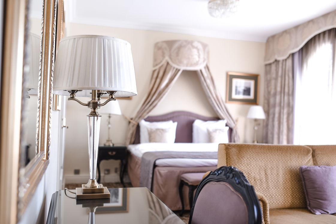 Luxury table lamp placed in a five-star hotel suite creating elegant ambient lighting and a prestigious interior atmosphere.