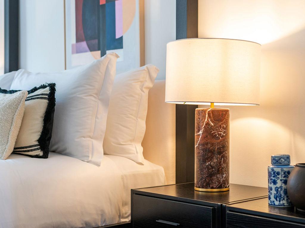 Luxury table lamp placed in a five-star hotel suite creating elegant ambient lighting and a prestigious interior atmosphere.
